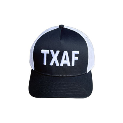 TXAF Trucker Hat in black and white with bold Texas embroidery.
